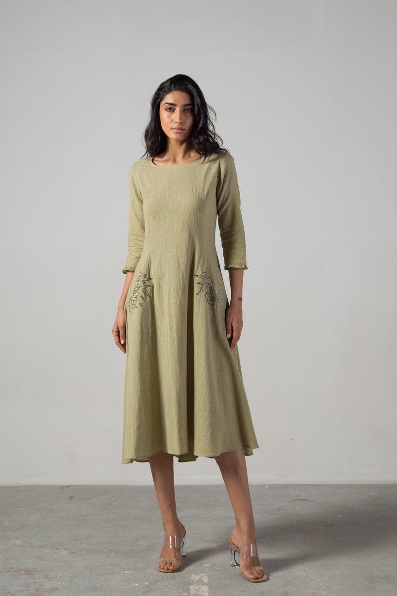 Green dress with cut panels embroidery